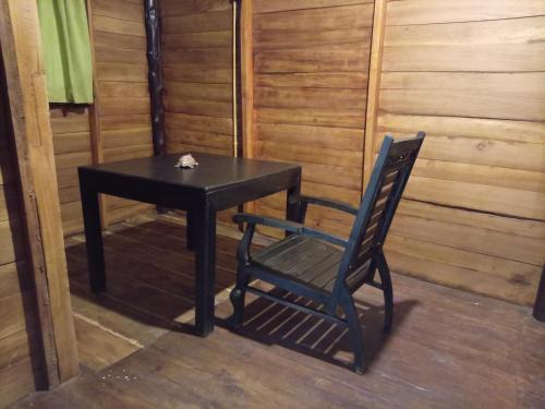 a black table and a chair in a room at Echo retreat in Tangalle