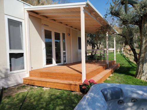 a wooden deck on the side of a house at Agricamping Est Garda Home Rubino in Lazise
