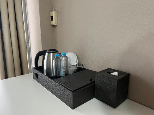 a black tray with bottles and a box at BT fifty in Bangkok