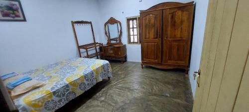 a bedroom with a bed and a dresser and a mirror at MD Retreat in Kalpitiya