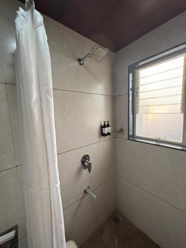 a bathroom with a shower with a shower curtain at Sunny Executive in Satara