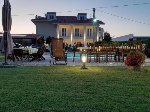 a yard with chairs and tables and a house at Villa Miranda in Ortona
