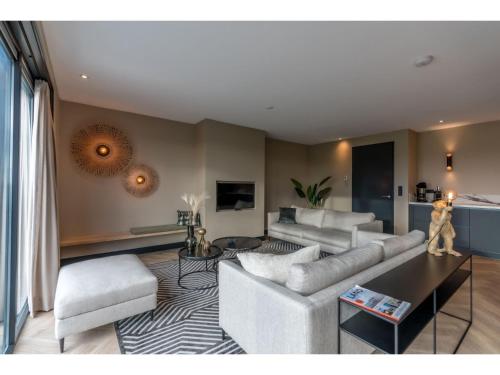 a living room with a couch and a table at Modern villa in De Cocksdorp near the beach in De Cocksdorp