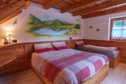 En eller flere senge i et værelse på Chalet Canedi - Maso dei Cuori