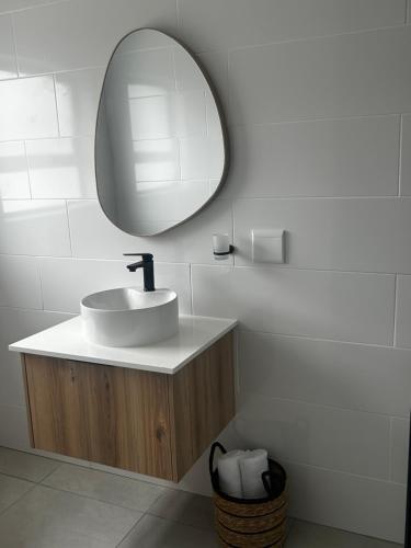 a bathroom with a sink and a mirror at The Spear Guest Lodge in Graskop