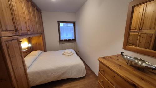 En eller flere senge i et værelse på Dolomiti Sweet Home