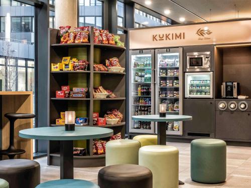 a store with two tables andools and a refrigerator at ibis Styles Stuttgart Vaihingen in Stuttgart