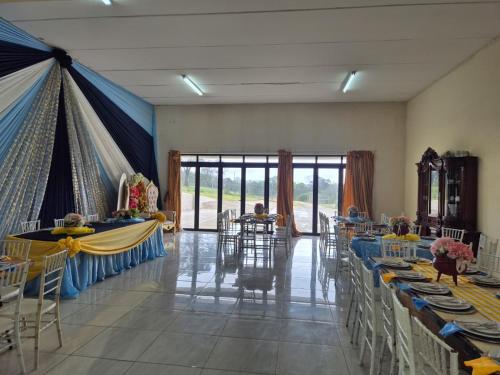 a banquet hall with tables and chairs with people sitting at them at Morogoro Park Lodge 