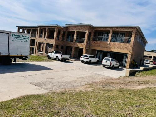 a large brick building with cars parked in a parking lot at Morogoro Park Lodge 
