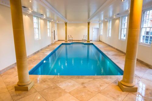 a large swimming pool in a large room with columns at Netley Hall in Shrewsbury