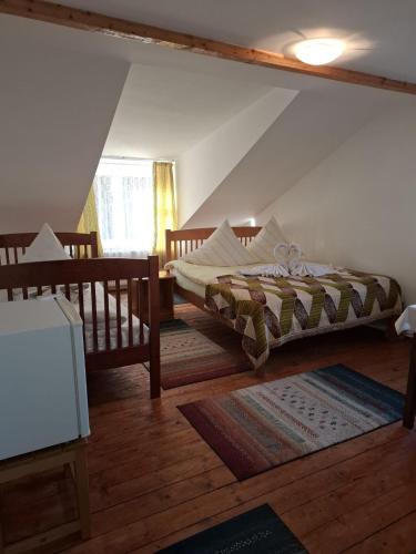 a bedroom with two beds in a attic at Vila Apuseni in Arieşeni