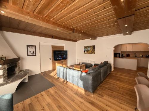 a living room with a couch and a fireplace at Panorama Quartier Seefeld in Seefeld in Tirol