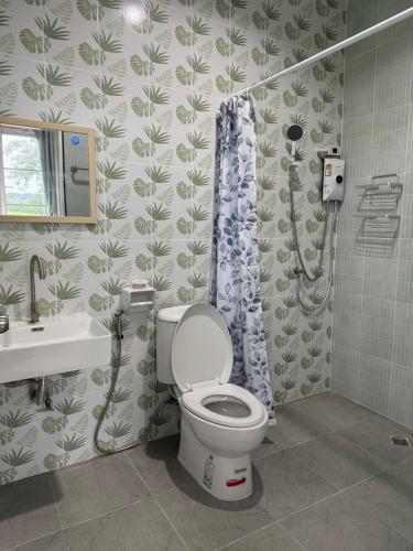 a bathroom with a toilet and a shower at บ้านไร่สกายดาว in Pak Chong