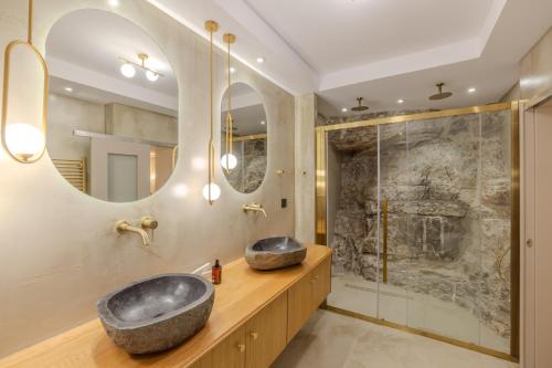 a bathroom with a large sink and a shower at Onora Suites Nafplio in Nafplio