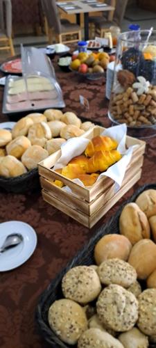 a table topped with baskets of bread and pastries at Hotel Durao in Viseu