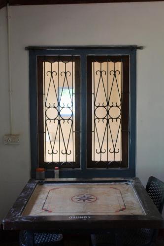 a window in a room with a table and chairs at River view cottage in Vythiri