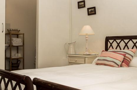 a bedroom with a bed with two pillows and a lamp at Olmitos 3, Casa-Palacio Real Piedad in Cehegín