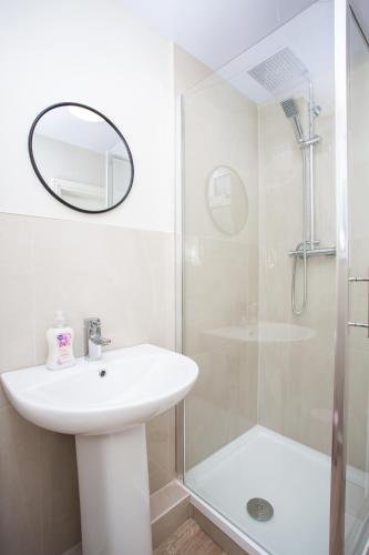 a white bathroom with a sink and a shower at Vacant Nests The Allendale Central 3BR in Allendale Town