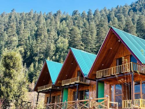 a large wooden house with a green roof at A-Frame Cabins in Sainj