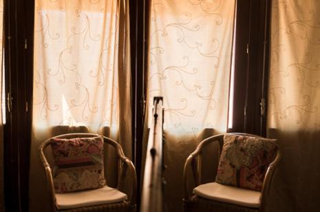 two chairs in front of a window with curtains at Olmitos 3, Casa-Palacio Real Piedad in Cehegín