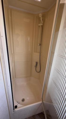 a shower with a glass door in a bathroom at Suntrail House in Great Clacton