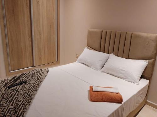 a bedroom with a large white bed with white pillows at Les belles loges in Bouskoura