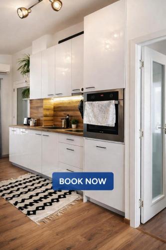 a kitchen with white cabinets and an oven at Charming City Apartment SIYANA - Self Check-in in Panagyurishte
