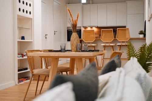 a kitchen and dining room with a table and chairs at Portside Residence Piräus in Piraeus