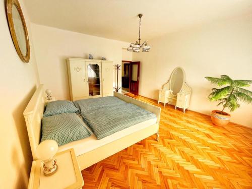 a bedroom with a bed and a wooden floor at First Republic Apartment Strahov in Prague