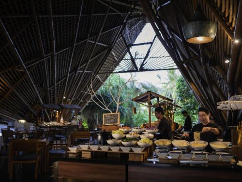 a group of people standing in a room with food at Kuredhivaru Resort and Spa - Maldives in Manadhoo