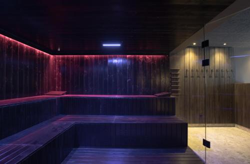 a room with a stage with a red curtain at Aparthotel Familiaris - Family Apartments - Pools & Spa in Dolomites in Valdaora