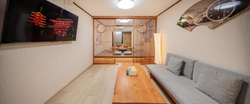 a living room with a couch and a table at Family House 蕾 池袋徒步圈全新装修日式户建民宿 in Tokyo