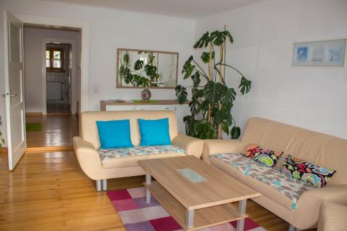 a living room with two couches and a coffee table at Ferienwohnung Treml in Bayerisch Eisenstein