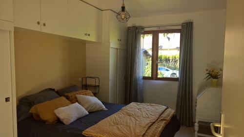 En eller flere senge i et værelse på Charmant cocon, jardin, aux portes de Verneuil