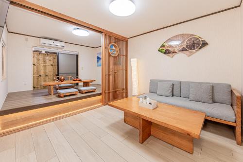 a living room with a couch and a table at Family House 蕾 池袋徒步圈全新装修日式户建民宿 in Tokyo