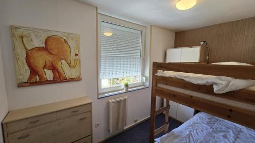 En eller flere senge i et værelse på Ferienhaus Hafenperle