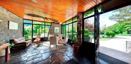 a living room with glass doors and a patio at Silken Ordesa in Torla