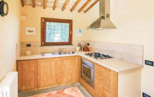 a kitchen with a sink and a stove at Podere Macee Casavacanza in Baschi