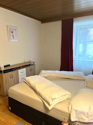 two twin beds in a room with a window at Stadtwohnung Bruck an der Mur in Bruck an der Mur