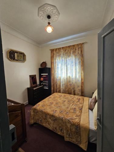 a hotel room with a bed and a window at Marrakech plus in Marrakesh
