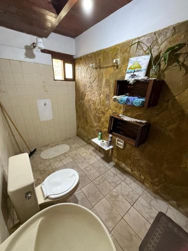 a bathroom with a toilet and a sink and a piano at Cabaña Virginia in Samaipata
