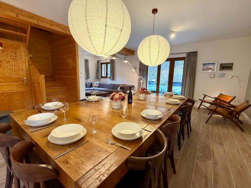 een eetkamer met een grote houten tafel en stoelen bij Chalet Les Ecrins in Vénosc