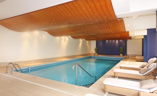 
a bath room with a tub and a pool at Royal Plaza Montreux in Montreux
