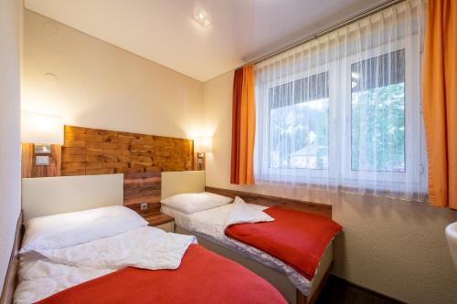 En eller flere senge i et værelse på Apartment - Camping Brunner am See