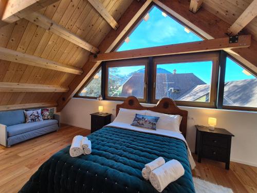 a bedroom with a large bed in a attic at NEW Locanda da Raimondo - das Knarren der Zeit in Tarvisio