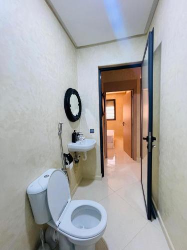 a bathroom with a toilet and a sink at Blue Wave Surf House in Mirleft