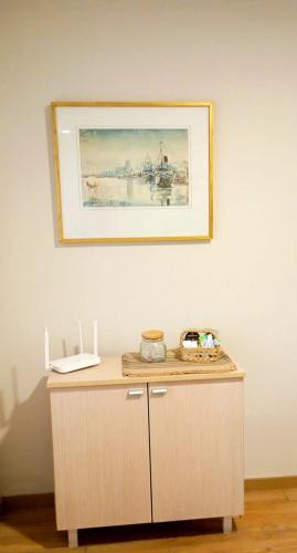 a picture hanging on a wall above a wooden table at Apart del Puerto 01 cochera opcional in Santa Fe