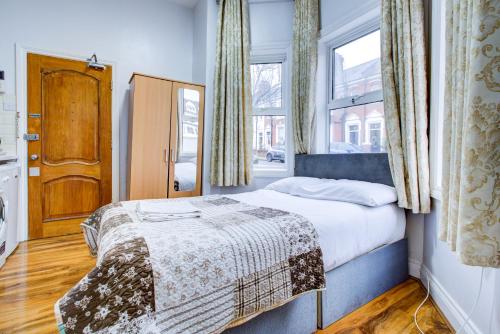 a small bedroom with a bed and a window at Bryanston Camden Hotel in London