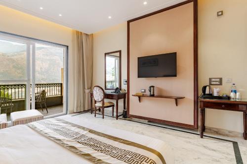 a hotel room with a bed and a tv on a wall at The Himalayan Residency in Duttnager