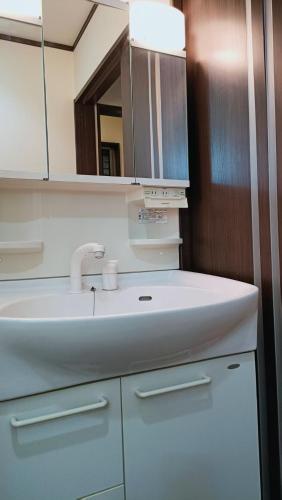 a bathroom with a white sink and a mirror at 京旅别莊 in Kyoto